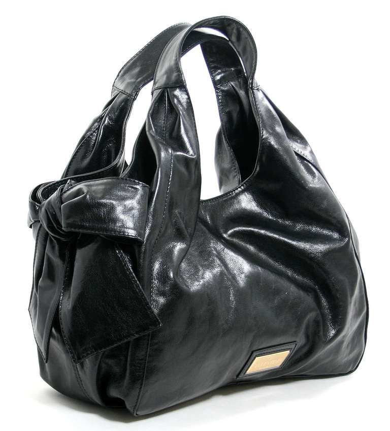 This strikingly feminine Valentino Black Leather Nuage Bow Hobo is brand new.  The protective plastic is still intact on the gold Valentino engraved plate.    Signature Valentino  details are exceptionally beautiful in edgy black calfskin, a rarely