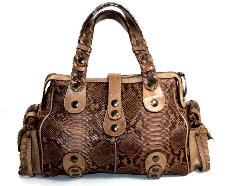 A stunning exotic, this Chloe Natural Python Silverado Satchel is a fantastic find in truly excellent condition.  There are minor scratches and subtle water marks on the leather trimmings that are consistent with gentle use.  The iconic Silverado