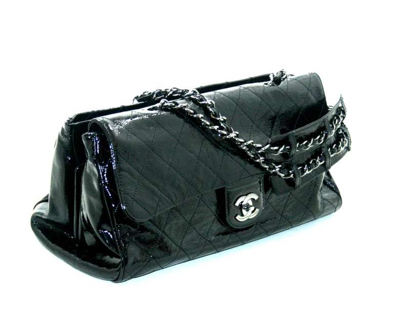 Beautiful and timeless, this Chanel Black Patent Leather Ritz  Bag is nearly pristine with only very minor signs of prior ownership.   The Ritz combines multiple styles into one incredibly functional and stylish piece that can be carried as a