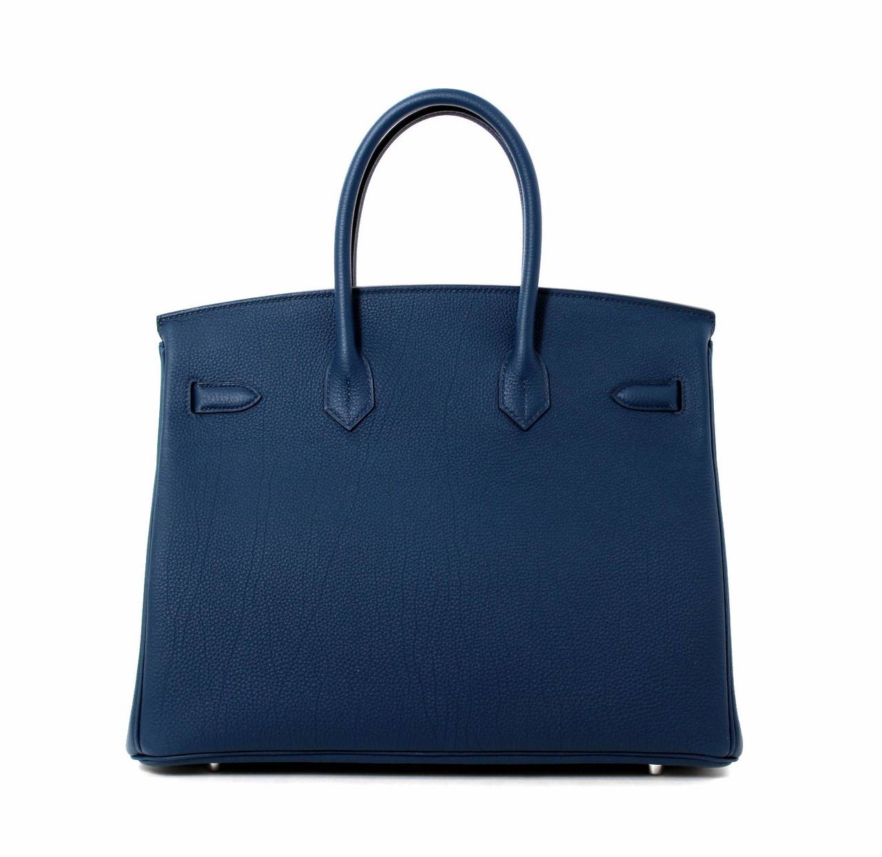 Pristine, store fresh condition (plastic on hardware) Hermès Birkin Bag in Bleu de Prusse Togo Leather with Palladium Hardware, 35 cm size.   
Crafted by hand and considered by many as the epitome of luxury items, Birkins are extremely difficult
