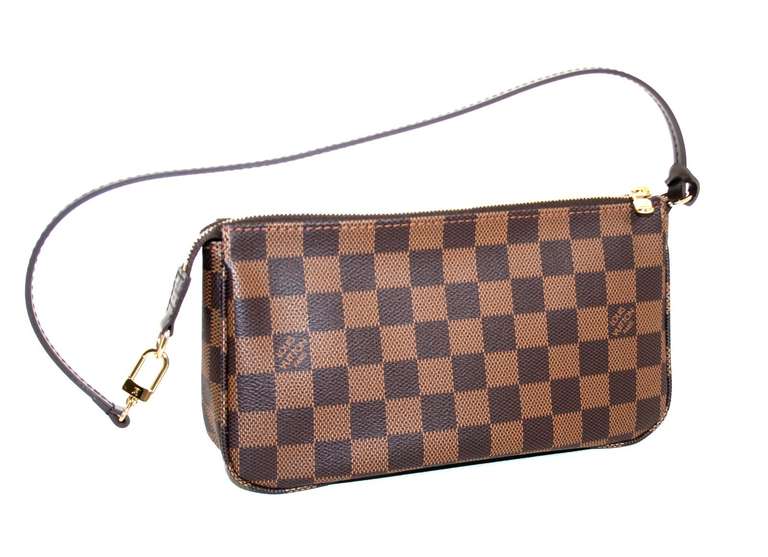 Louis Vuitton’s Damier Ebene Pochette is a current LV style in pristine condition, appearing unworn.  Retailing for over $500.00 with taxes, this adorable and practical mini is a great find.  
Signature Louis Vuitton brown checkerboard patterned