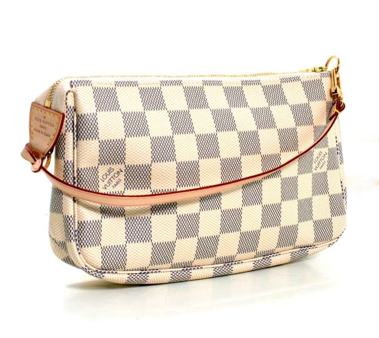 Appearing never carried, this Louis Vuitton Damier Azur Coated Canvas Pochette is a fantastic find.  The current style retails for over $500.00 with taxes and is a smart buy for a savvy shopper.  
Signature Louis Vuitton blue and cream checkerboard