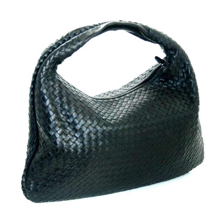 In pristine condition with no sign of prior ownership, this iconic Large Veneta from Bottega Veneta is a spectacular find.  In the most coveted color that never goes on sale, the black Veneta is a true classic and a smart buy at a significant