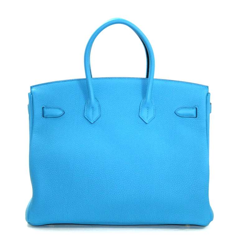 Pristine, store fresh condition (plastic on hardware) Hermès Birkin Bag in Turquoise Togo, 35 cm size.   Crafted by hand and considered by many as the epitome of luxury items, Birkins are extremely difficult to get. Scratch resistant and richly