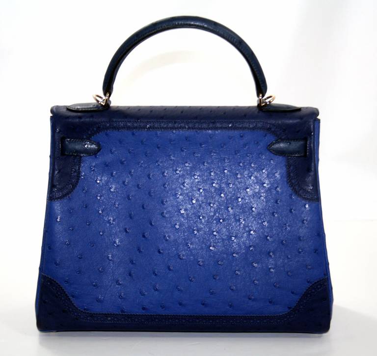 This highly collectible Hermès Blue Tricolor Ostrich Ghillies Kelly is in pristine unworn condition with the protective plastic intact on all the hardware.   Hermès bags are considered the ultimate luxury item worldwide.  Each piece is handcrafted