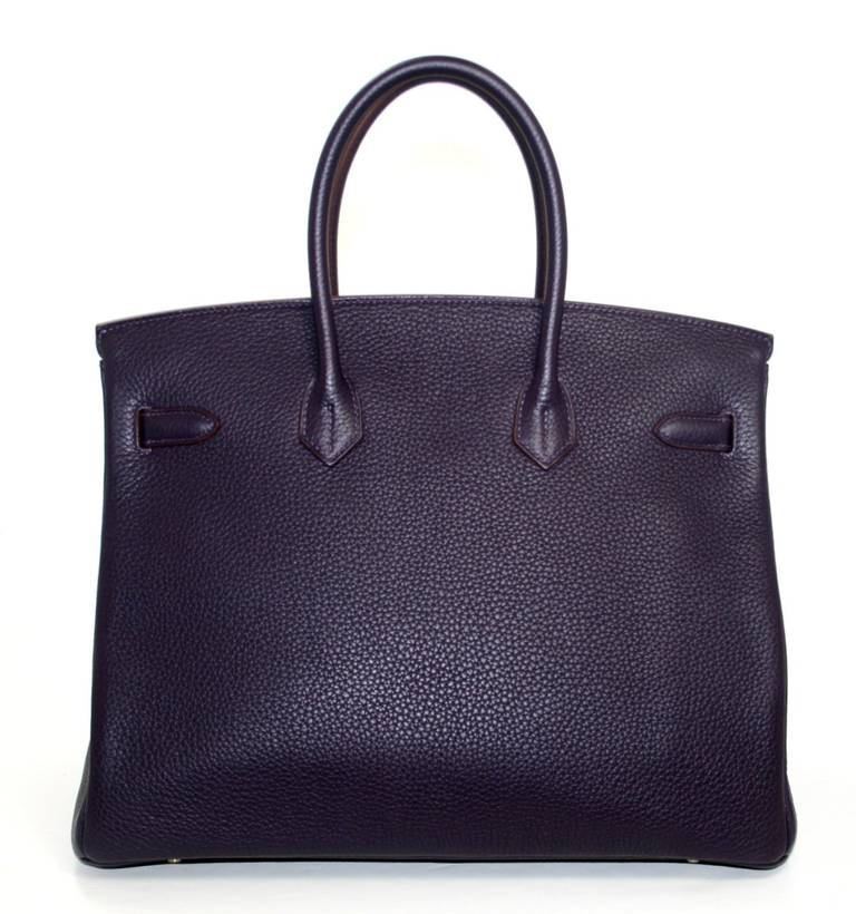 Never carried, this Hermès Raisin Clemence 35 cm Birkin is a beautiful piece for any collection.  It still has the protective plastic intact on the hardware and it has been carefully stored.   Considered the ultimate luxury item the world over and