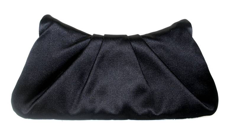 A beautiful addition to any sophisticated wardrobe, this Chanel Black Satin Evening Clutch is in better than excellent condition.  There are only a few very light micro scratches on the hardware.  The classic style is certain to become a fast