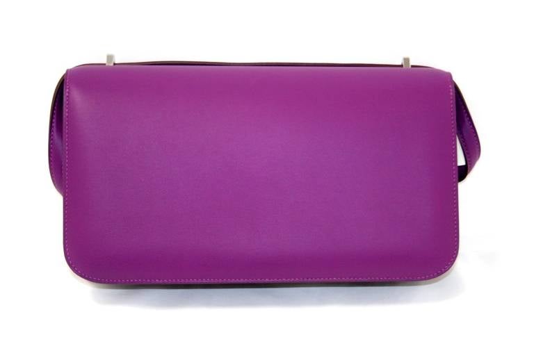 This authentic Hermès Ultra Violet Swift Leather Constance Elan has never been carried.  It is in pristine condition with the protective plastic intact on the hardware. One of Jackie-O’s favorite Hermès styles, she was often photographed wearing