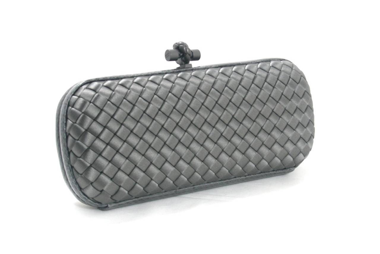 Bottega Veneta’s Ardoise Satin and Ayers Skin Stretch Knot Clutch is brand new.  The classic collectible is a timeless style that retails for over $1,750.00 with taxes and is an indispensable part of any wardrobe.  
 The iconic Bottega Veneta