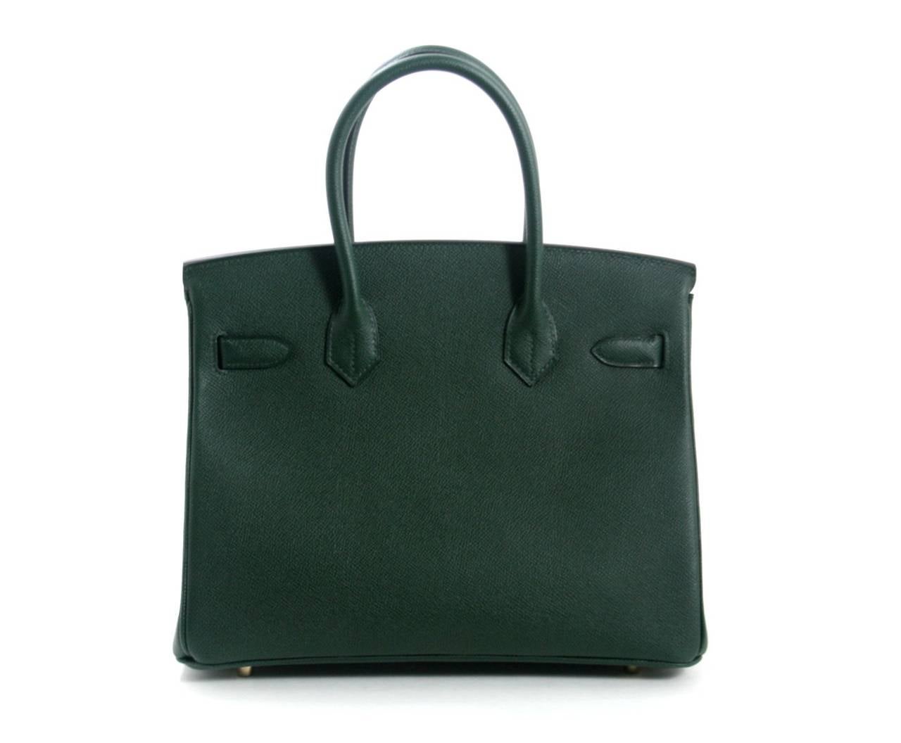 Pristine and never before carried, this Hermès Vert Anglais Epsom Leather 30 cm Birkin is in the newest shade of  green from the 2014-2015 collection.    The protective plastic is intact on all the hardware and it has been carefully stored.   Hermès