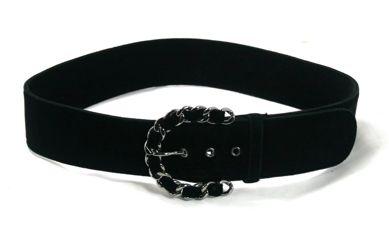 Chanel’s Black Velvet Belt is in excellent condition with minimal signs of prior ownership.  We believe this is from the 2006 collection.  
Black velvet belt has silver tone interwoven chain buckle and three grommets, varying the belt length from