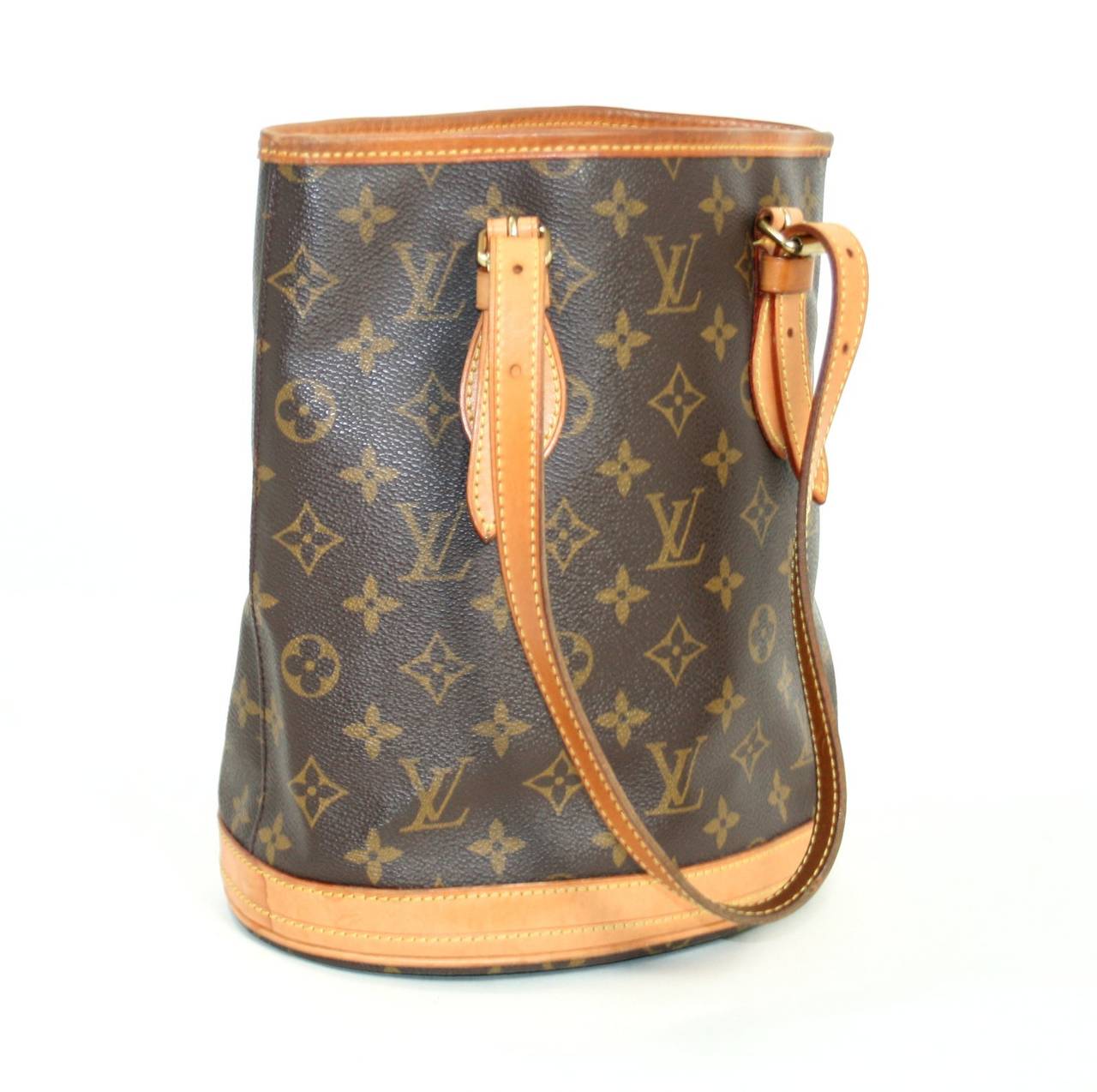 Louis Vuitton’s Monogram Petit Bucket Bag is a classic style in very good condition.  The exterior canvas appears excellent and the interior is very clean.  The natural cowhide has appropriately darkened with the honey colored patina associated with
