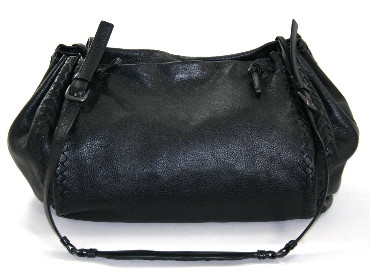 Bottega Veneta’s Black Cervo Messenger Bag is a fantastic find for a smart shopper.  It is in great overall condition.  The exterior looks excellent with just a bit of normal wrinkling.  The interior looks very good; there is a large pen mark on the