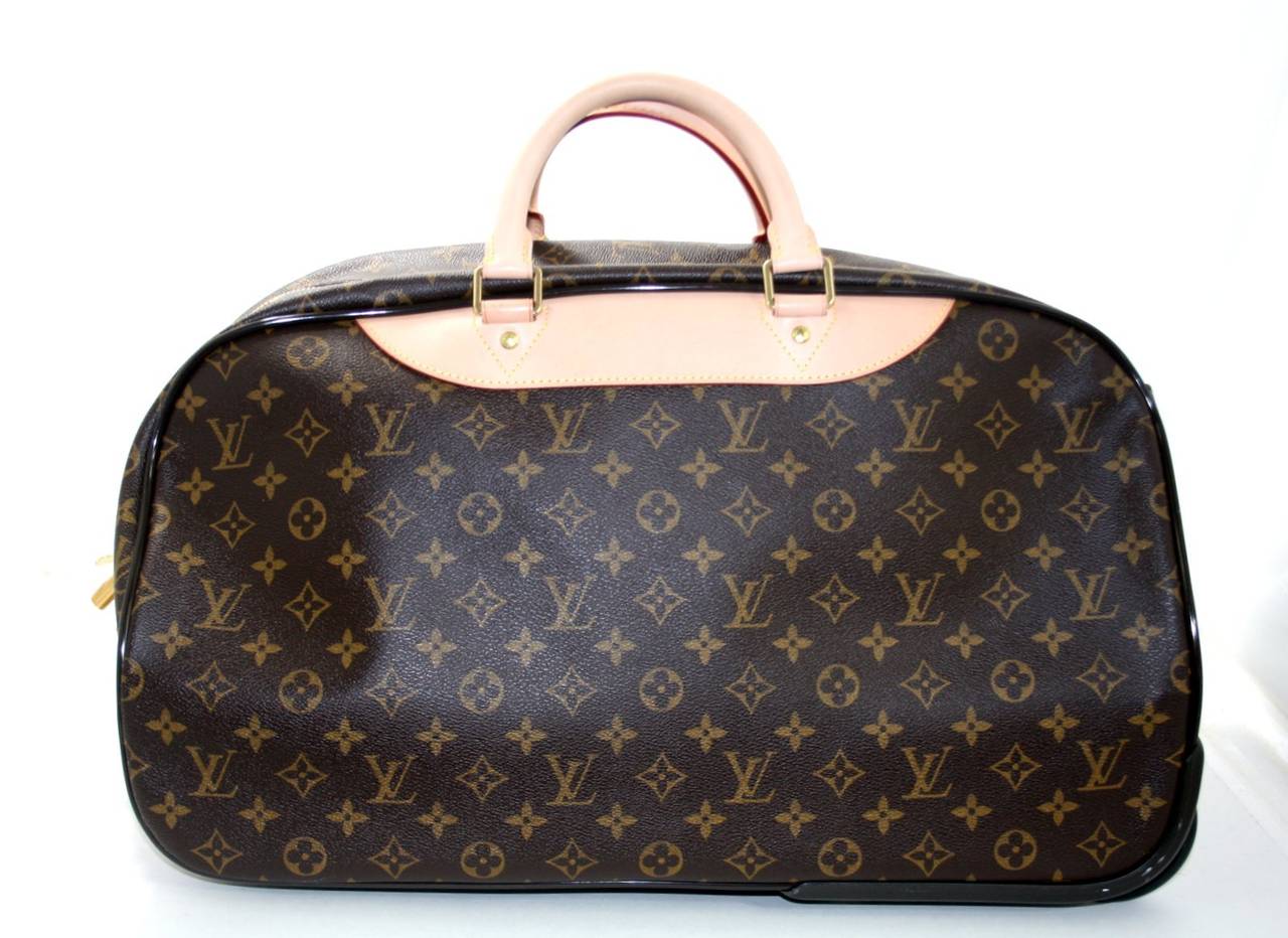 Louis Vuitton’s Eole 50 Monogram Rolling Travel Bag is in nearly pristine condition; the vachetta leather trim and handles have not yet begun to darken.    There are a few very minor scuffs near the bottom wheels; it was carried one time.  This
