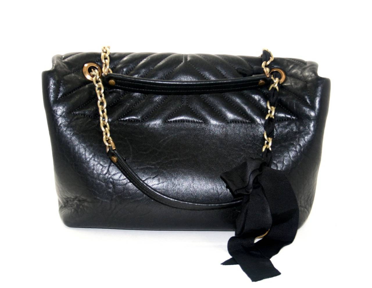 Lanvin’s Black Lambskin Large Happy Bag is in pristine condition.  A former store display, this iconic style is a brilliant find for a savvy shopper; it retails for over $2,780.00 with taxes. 
Black lambskin is quilted in a chevron pattern and