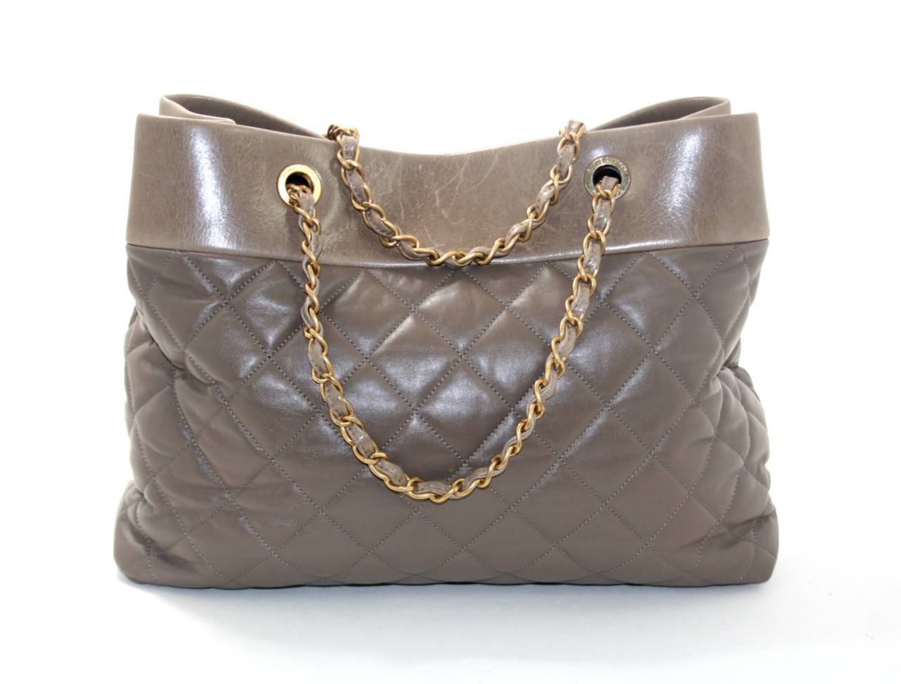 Chanel’s Taupe Leather Soft Elegance Tote is a fantastic find.  Carried one time, this beautiful tote retailed for over $4,000.00 with taxes.   The lighter top portion is a contrasting distressed leather; a few light mars can be seen on this portion