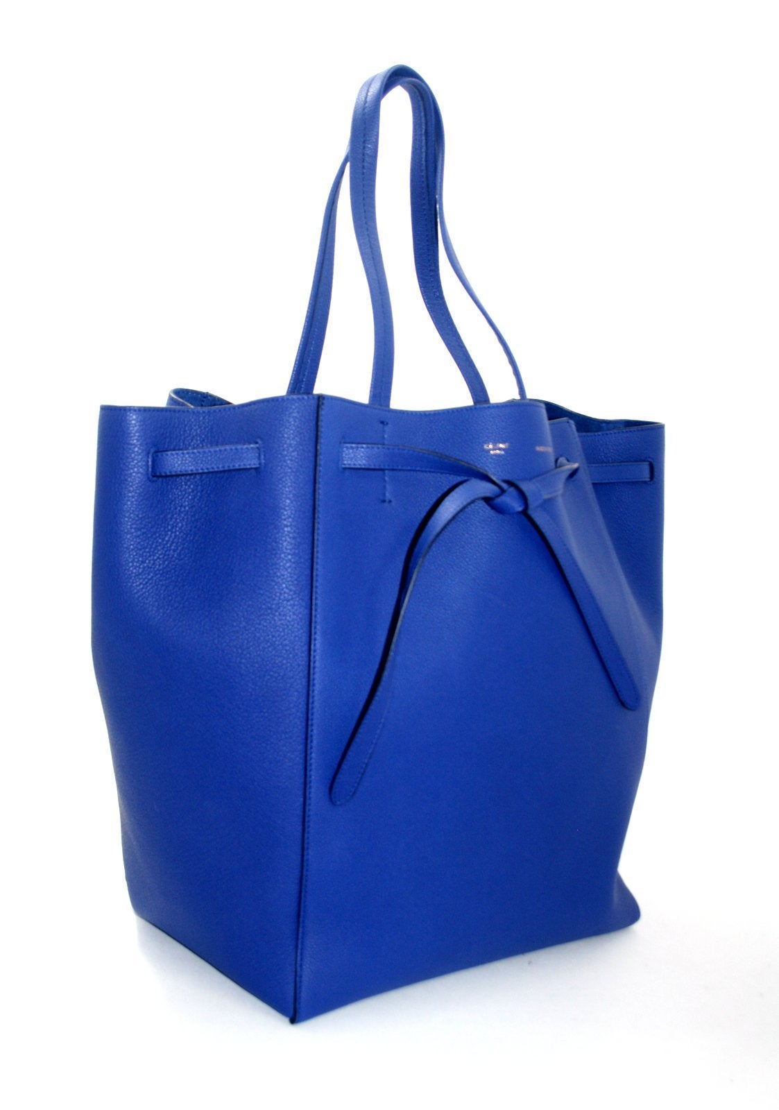 This authentic Celine Blue Leather Cabas Phantom Medium Tote is in pristine condition.  The understated silhouette may be worn with the sides flared out or tucked in; either way it easily holds all the essentials for a busy day. 

Cobalt blue