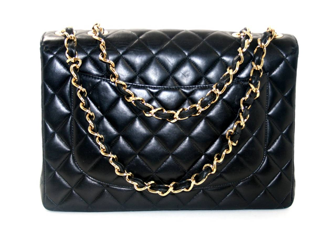 This Authentic Chanel Black Lambskin Vintage Jumbo Classic Flap is in mint condition with only very slight signs of prior ownership. Always coveted in black with gold hardware, the vintage Jumbo Classic is a special piece for any serious collection.