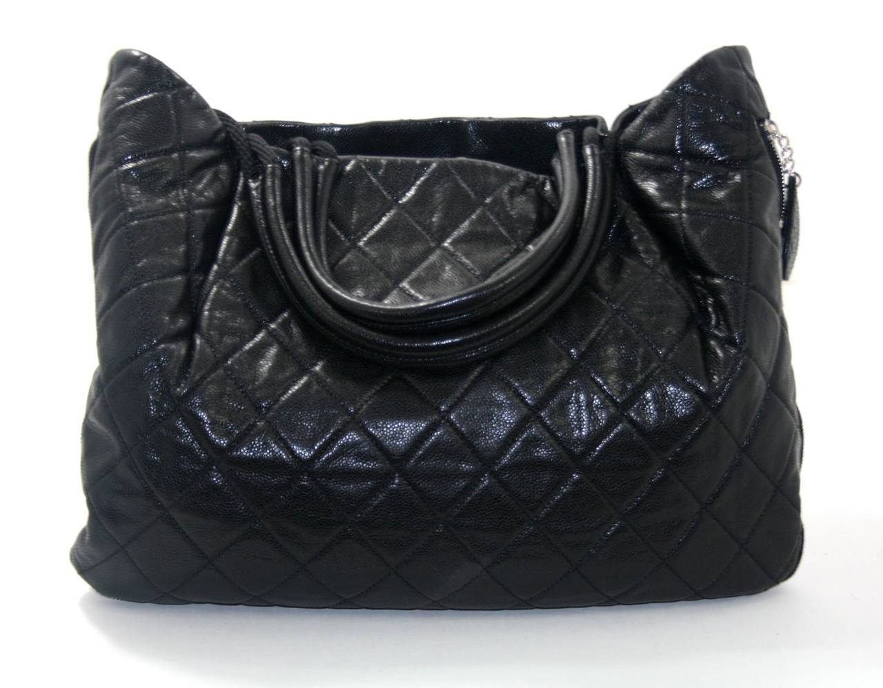 In better than excellent condition, this Black Caviar Expandable Zip Around Tote from Chanel’s 2010 Soho Edition Collection is a fabulous find.   The very roomy style is perfect for daily enjoyment or travel. 
Black durable caviar leather has a