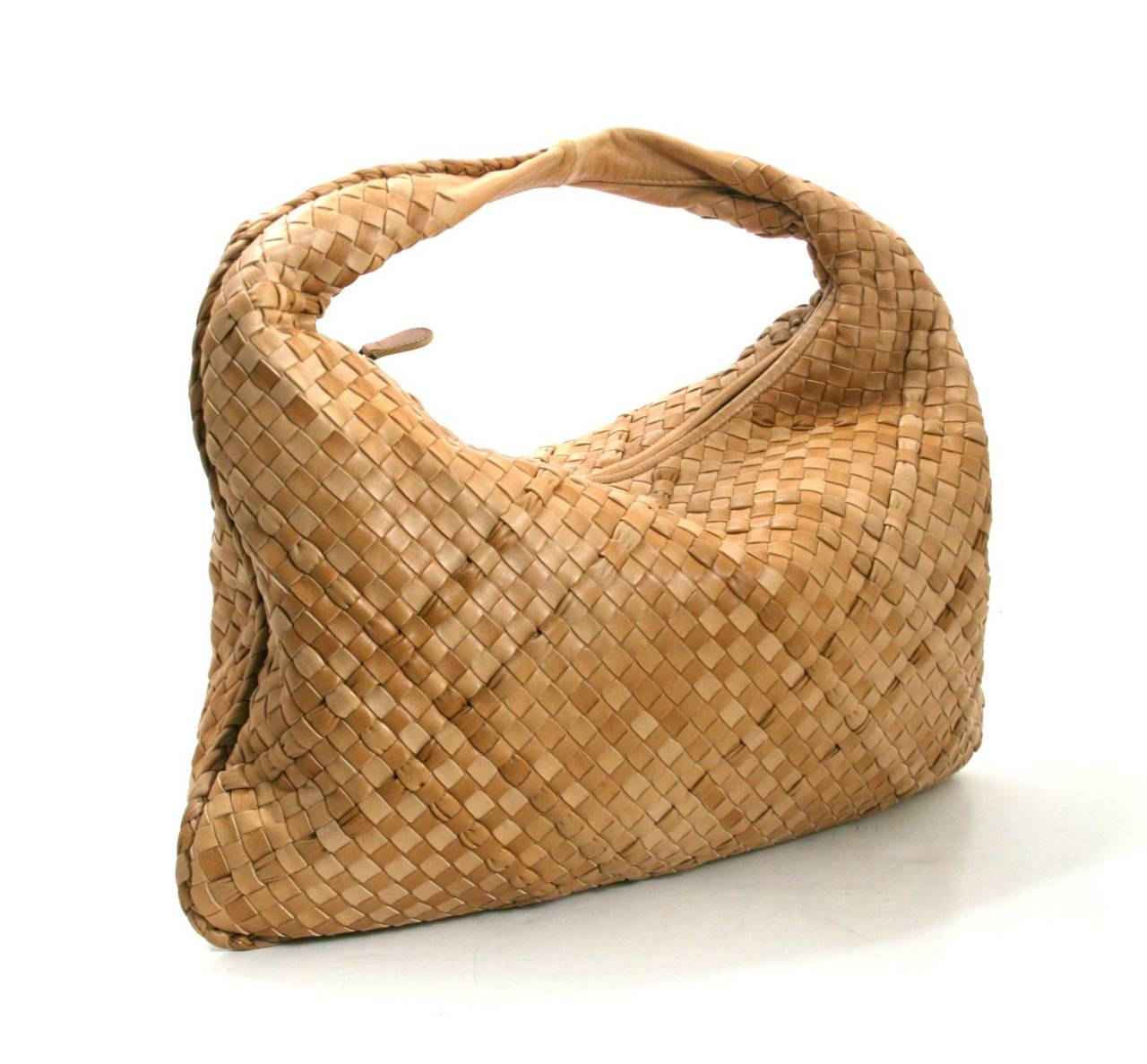 Bottega Veneta’s Paille Leather Large Veneta is a rare limited edition in mint condition. The neutral color and classic silhouette is a beautiful addition to any collection.  2010 retail price $2,250.00.
Warm variations of camel and beige lambskin