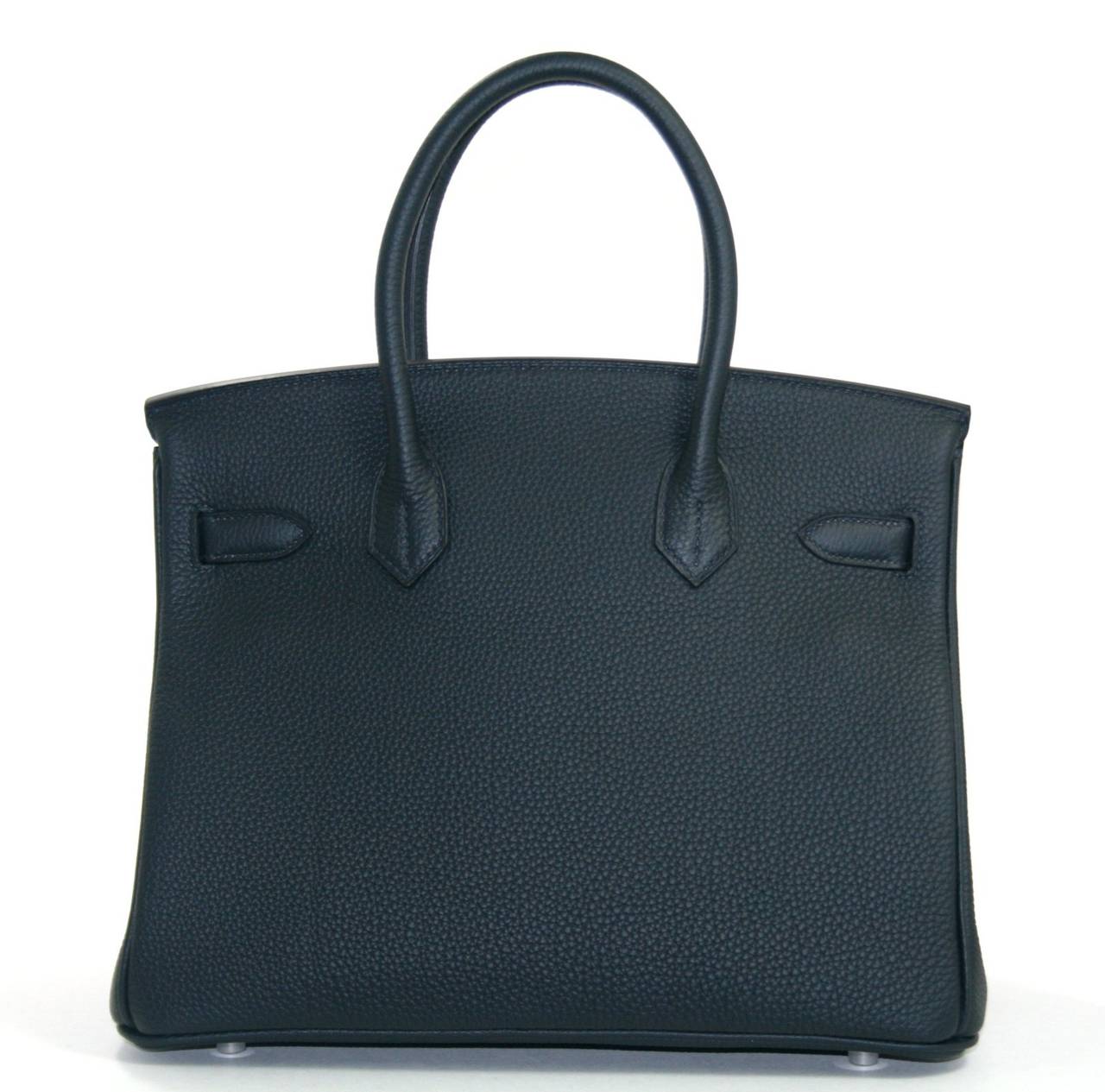 Pristine, store fresh condition (plastic on hardware) Hermès Birkin Bag in Blue Ocean (black color) Togo, 35 cm size.   Crafted by hand and considered by many as the epitome of luxury items, Birkins are extremely difficult to get. Scratch resistant