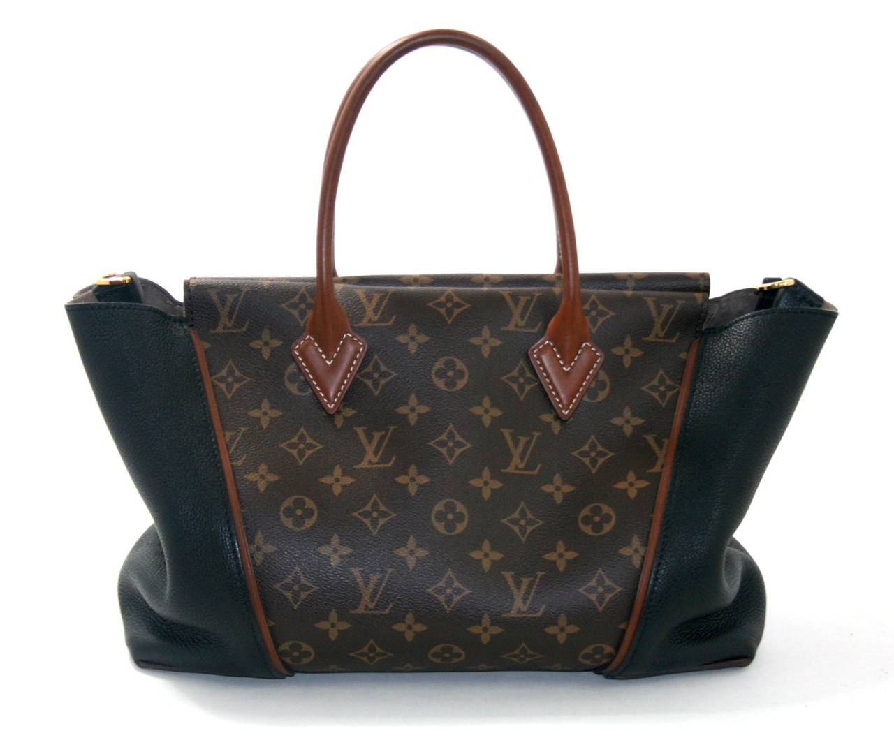 Louis Vuitton’s Noir Monogram W Tote in the PM size is a spectacular find in mint condition.  There is some very slight wear on the handles; please see photo.  The sophisticated style carries everything with ease for chic daily use in any