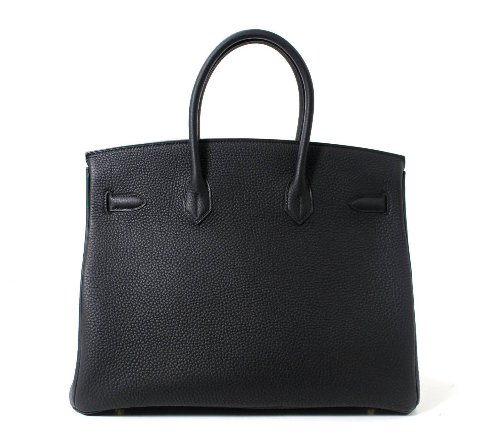 Pristine, store fresh condition (plastic on hardware) Hermès Birkin Bag in BLACK Togo Leather with GOLD hardware, 35 cm size T stamp
Crafted by hand and considered by many as the epitome of luxury items, Birkins are in extremely high demand but