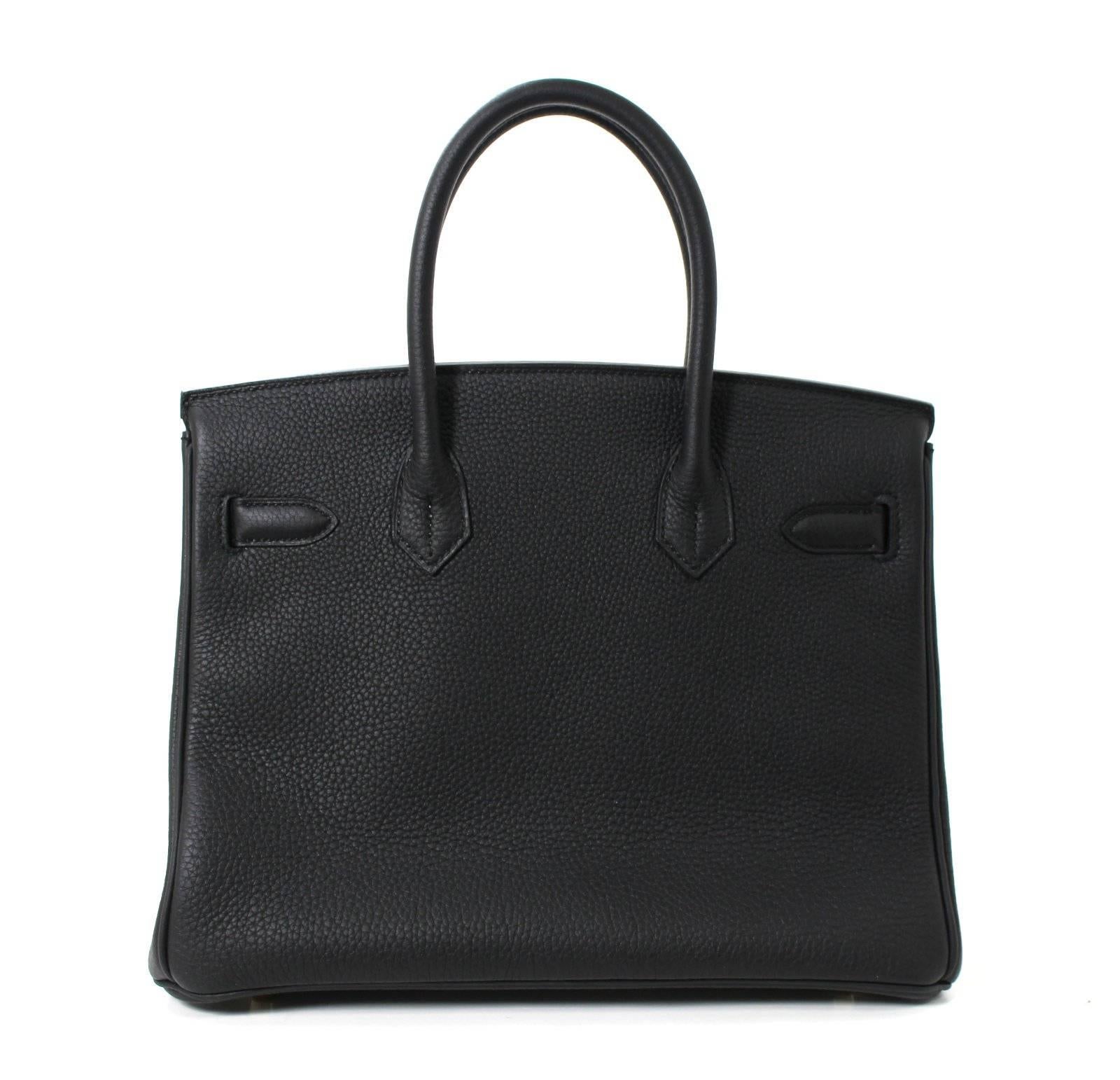 Pristine, store fresh condition (plastic on hardware) Hermès Birkin Bag in BLACK Togo Leather with GOLD hardware, 30 cm size.   
Crafted by hand and considered by many as the epitome of luxury items, Birkins are in extremely high demand but very