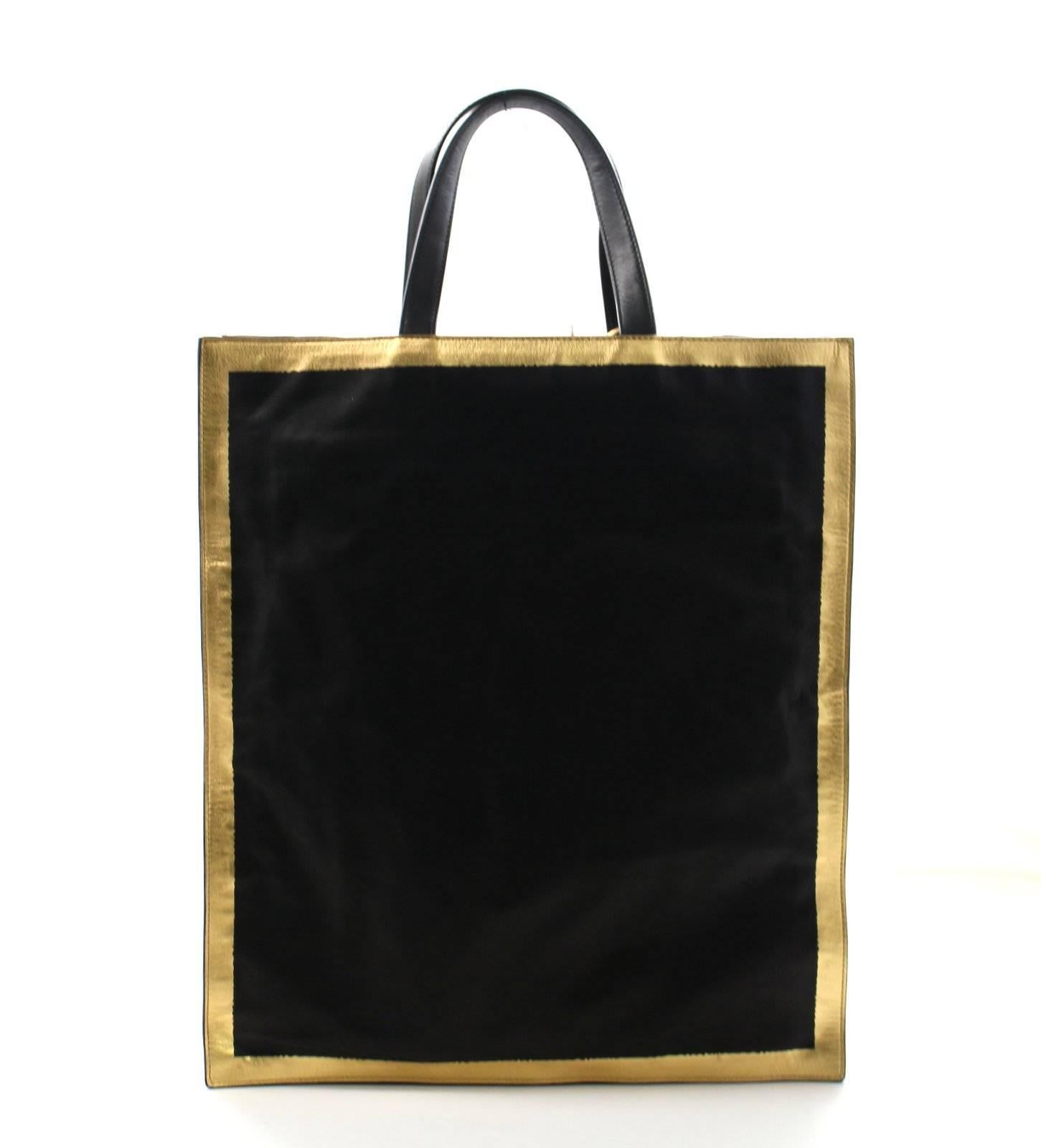 NEW, Never Carried!!!  Bottega Veneta Black Leather North South Tote Bag
Retail price $1,920.00
Soft black leather rectangular tote is slim and elegant.  Metallic gold leather geometrically trims the edges all the way around.  Double leather