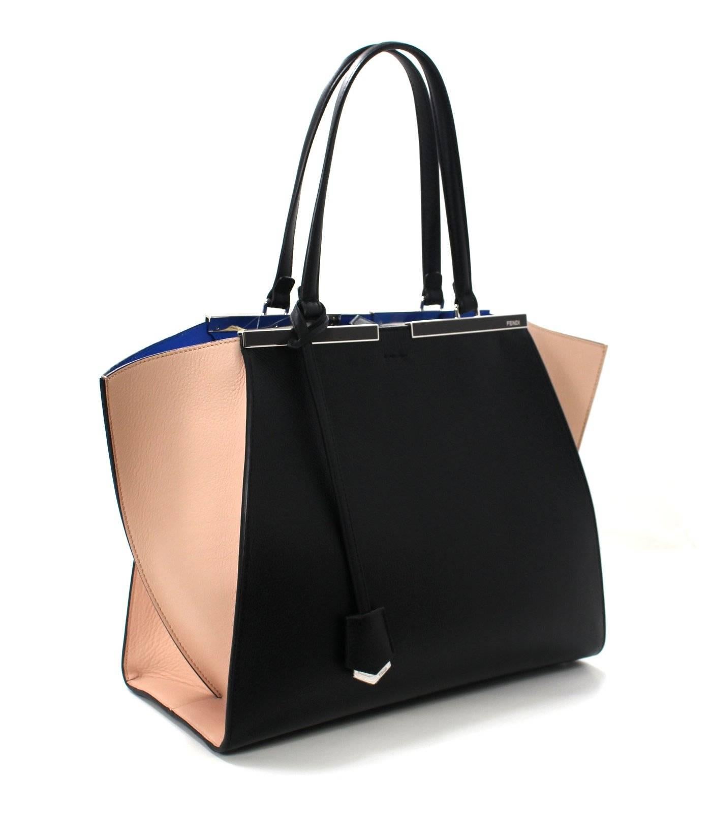 Pristine, Never Carried Fendi Black Tri Color Tote with tag  attached. Retail price $3,050.00.
 Adding color to your wardrobe is easy with Fendi’s clever design.  The striking blue interior  peeks out from within the walls of the black leather