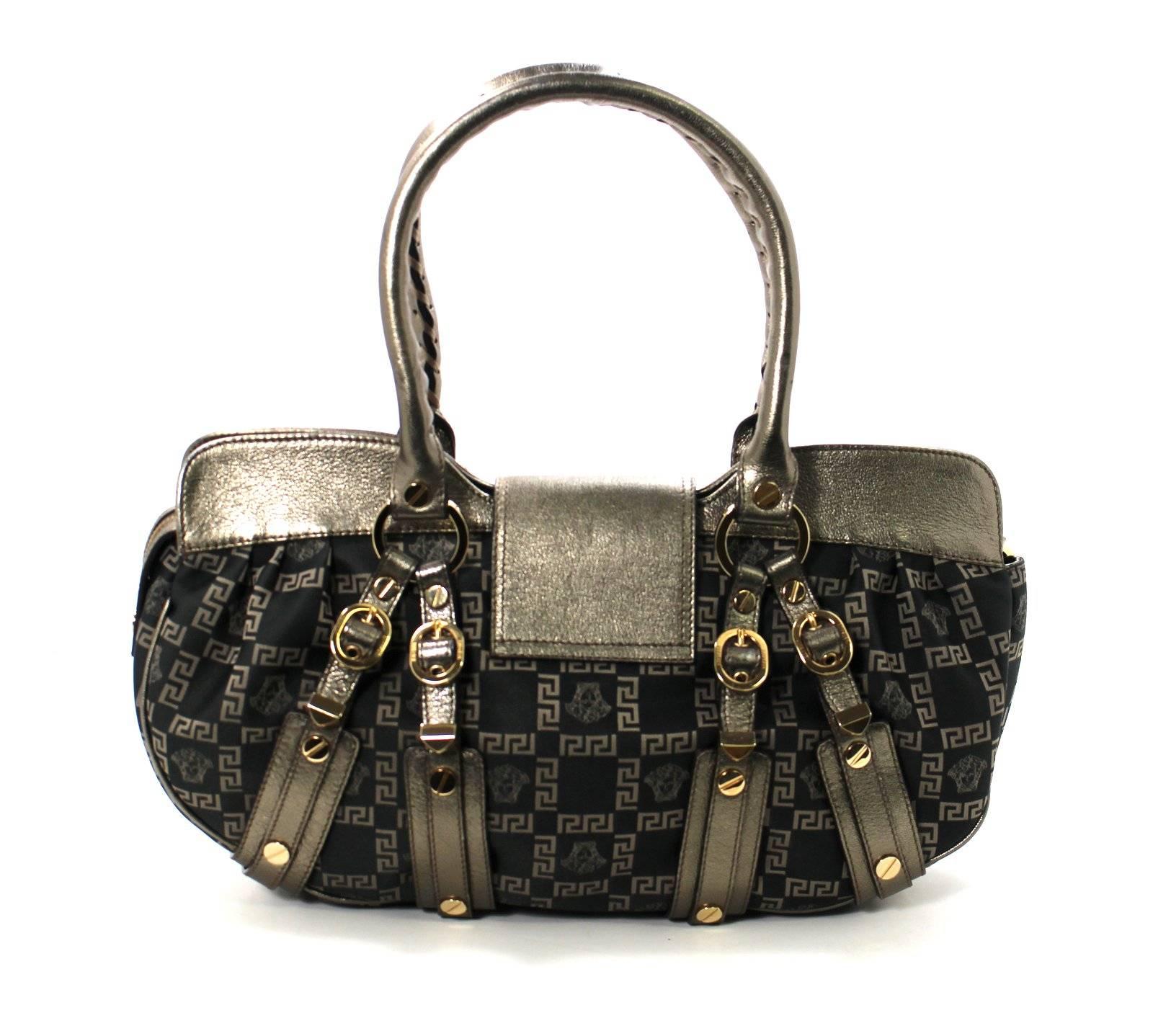 
MINT Condition- Versace Jacquard Medusa Buckle Bag approximate retail $1,095.00
Dark brown silk is accented with signature Versace print- Greek key pattern with Medusa heads.  Top zipper has a leather flap over with concealed magnetic closure