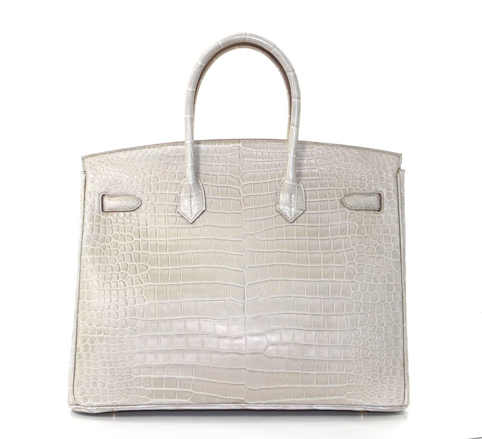 Pristine, store fresh condition (plastic on hardware) Hermès Birkin Bag in BETON Matte Porosus Crocodile, GHW 35 cm, T stamp

Crafted by hand and considered by many as the epitome of luxury items, Birkins are in extremely high demand but very