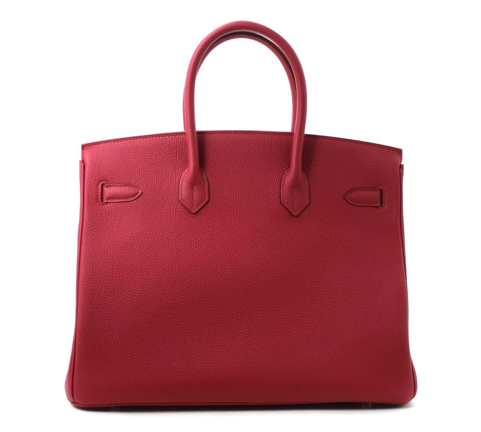 Pristine, store fresh condition (plastic on hardware) Hermès Birkin Bag in RUBIS Togo, PHW 35 cm, T stamp
Purchase includes padlock, keys, clochette, protective felt, raincoat, dust bags and Hermès box with tissue. 
Crafted by hand and