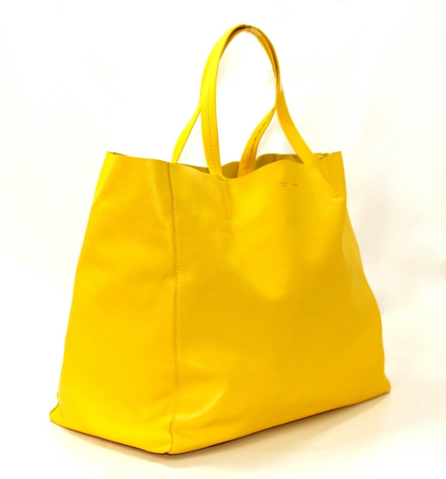 Celine Yellow Lambskin Horizontal Cabas Tote- Brand New, Retail $1,300.00
Iconic style from Celine in extremely desirable care free Sun Yellow.  
Lambskin horizontal tote in Sun yellow.     Double straps are comfortably carried on the shoulder. 