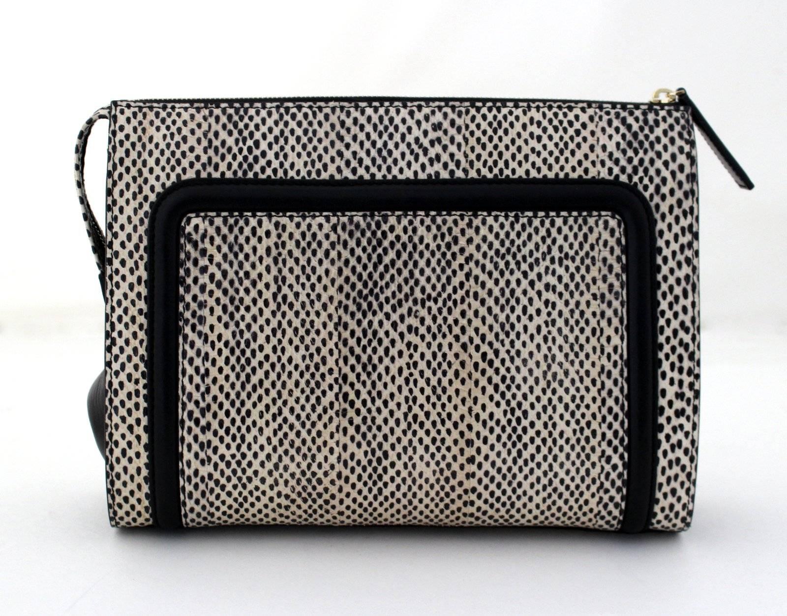 Jason Wu Daphne Water Snake Clutch- Current Retail $1,695.00
Never carried but there are minor surface scratches on the hardware from light handling.  
Nude and black water snake has a unique spotted pattern that is perfectly accented with black