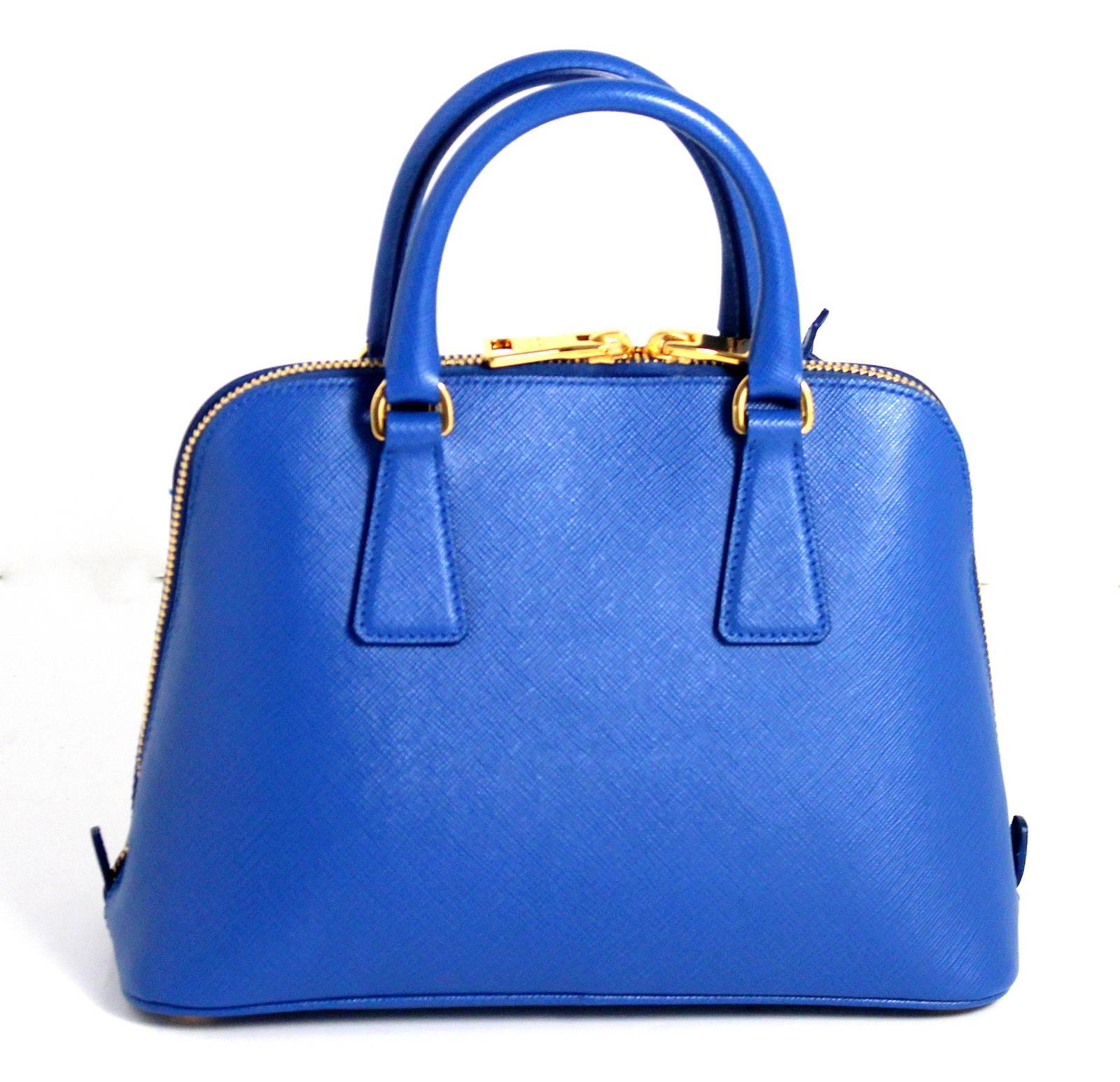 Prada Cobalt Blue Saffiano Lux Promenade Mini- Retail price $1,990.00
 Nearly PRISTINE; perhaps carried once or twice. 
In vivid cobalt blue color known as Azzuro with gold hardware.  The style is a current classic but totally sold out in Azzuro.