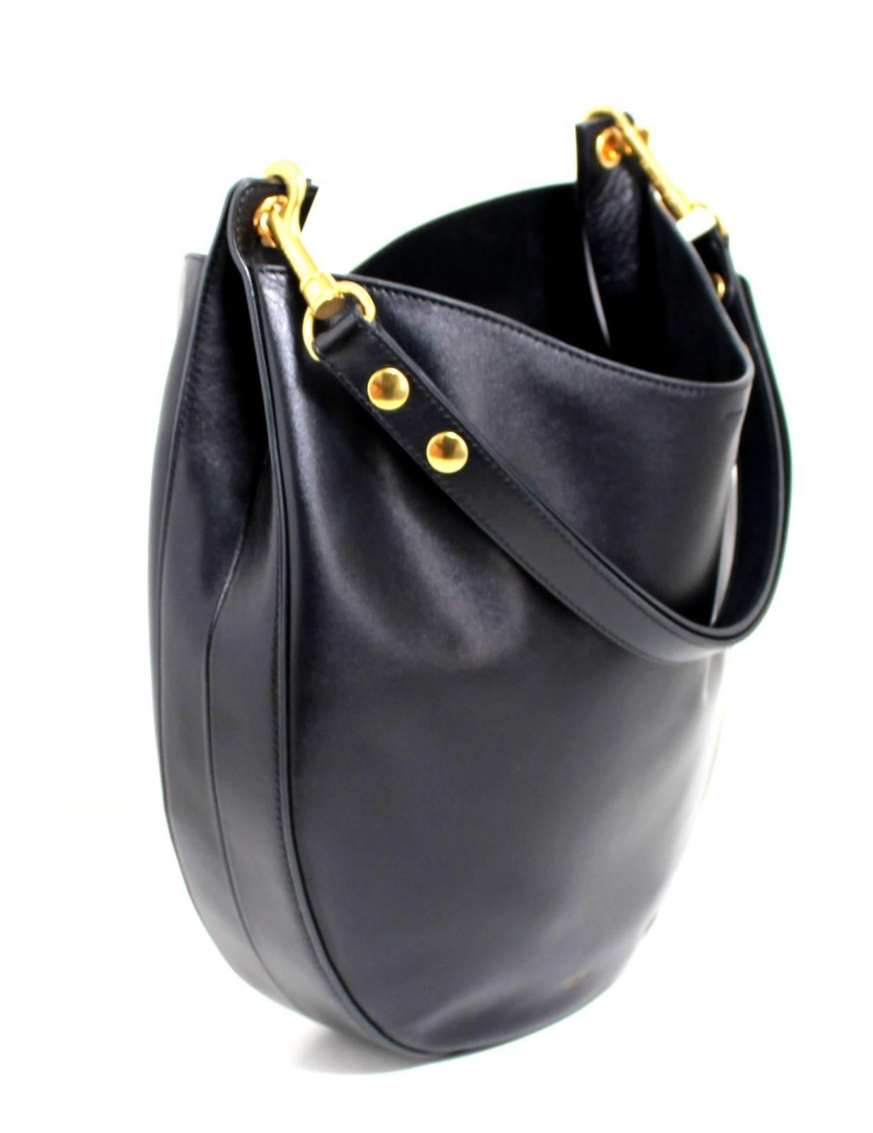 Celine Black Leather Medium Hobo-  Brand New
Retail Price $2,800.00

Timeless structured hobo style in rich smooth leather with gold hardware.  Mild marring is expected with this type of leather and does not detract in any way. Femininely curved