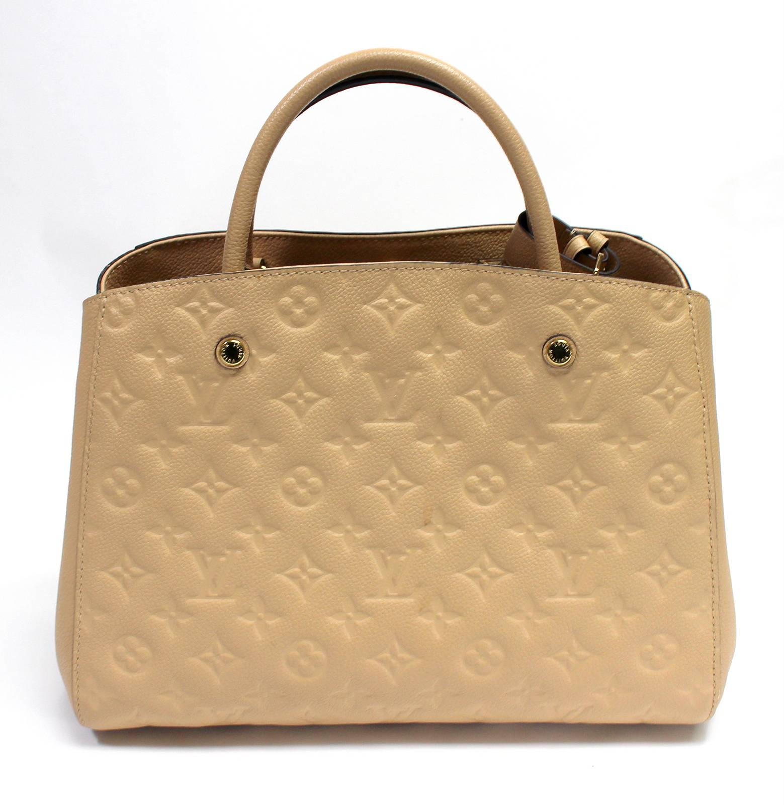 Louis Vuitton Dune Empreinte Montaigne MM- Near Pristine 
Retail $3,250.00
Textured monogram empreinte leather in year round neutral Dune color with gold hardware.  Central zippered compartment, double rolled leather handles and protective footed