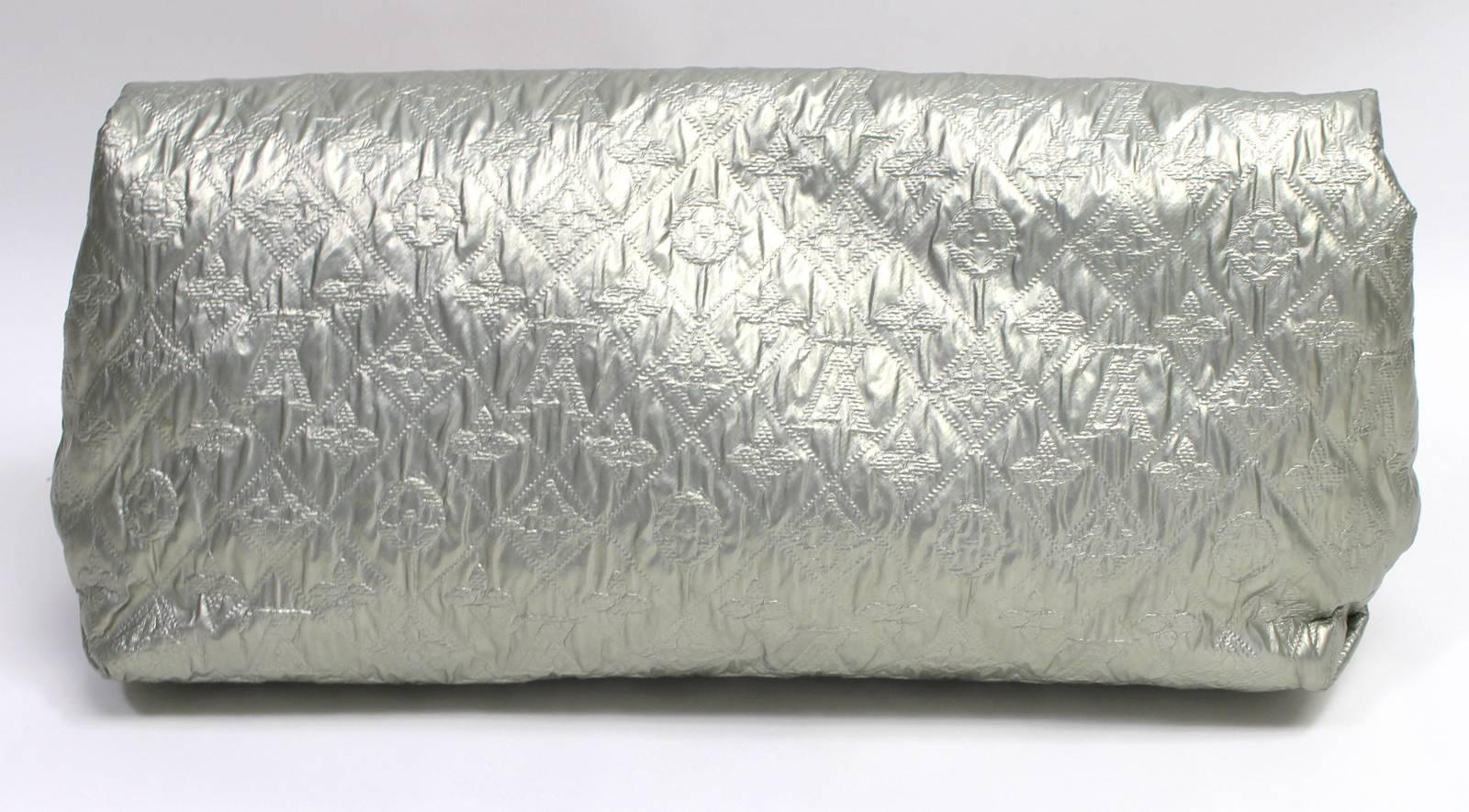 Louis Vuitton Silver Monogram Limelight GM Clutch- Excellent Plus Condition  
From the 2007 collection, the sophisticated piece complements any ensemble.  The exterior appears as new.
Matte silver oversized fabric clutch is quilted with signature