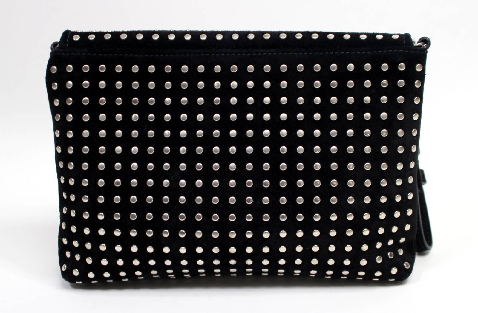 Alexander McQueen Black Suede Convertible Clutch- EXCELLENT; estimated current value $1,200.00.
 Subtle wear includes minor scuffs on the corners.  Please review photos.
Black suede rectangular clutch is covered in silver flat head studs.  A crystal