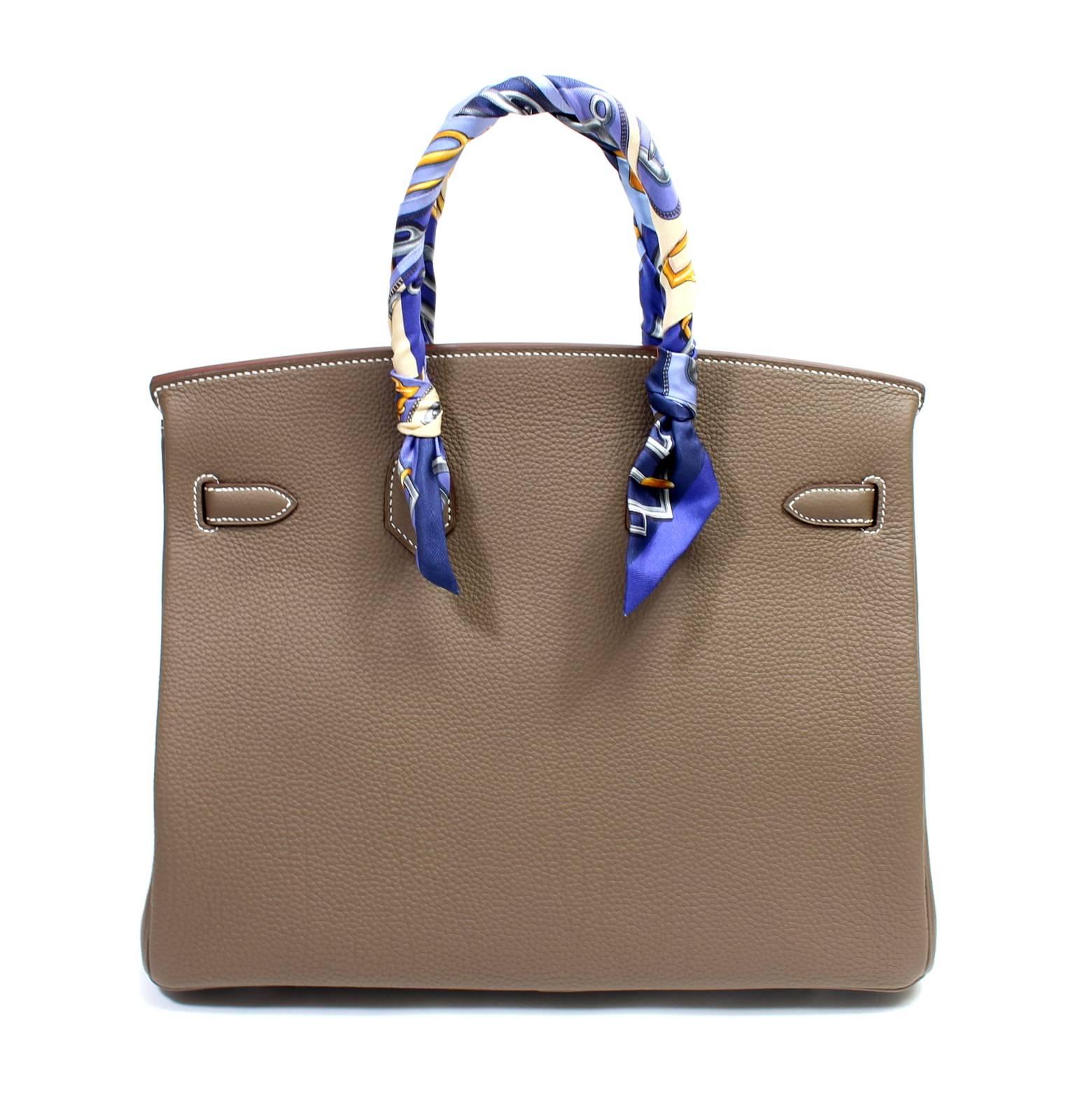 Hermès Etoupe Togo 35 cm Birkin Bag- PRISTINE; store fresh with plastic on all the hardware. 

Wildly sought after greige neutral, known as Etoupe, can be carried year-round.
 Handcrafted by skilled craftsmen and coveted by the fashion elite around