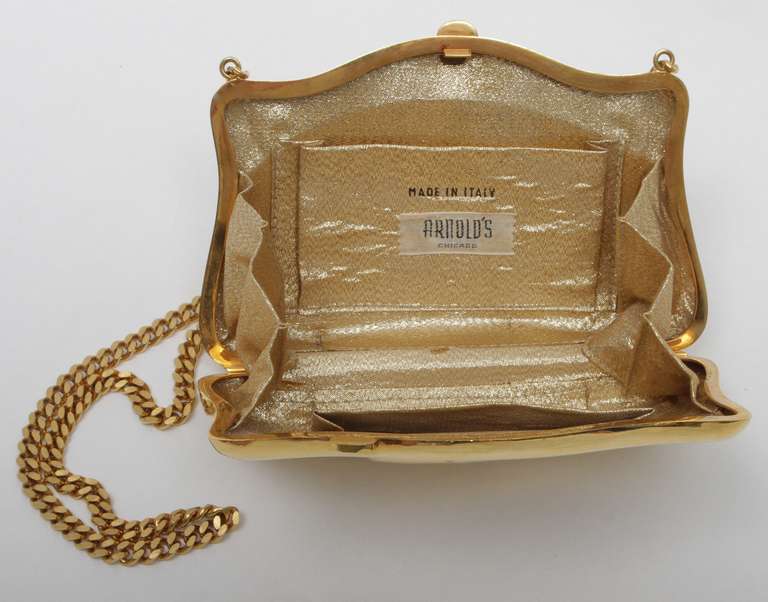 Very rare 70's shiny gold tone metal Carlos Falchi purse. Lined in gold lame fabric, unsigned, labeled with American boutique (Arnold's) name. Solid shiny, flat cut gold tone metal chain strap.
Kept in mint condition.