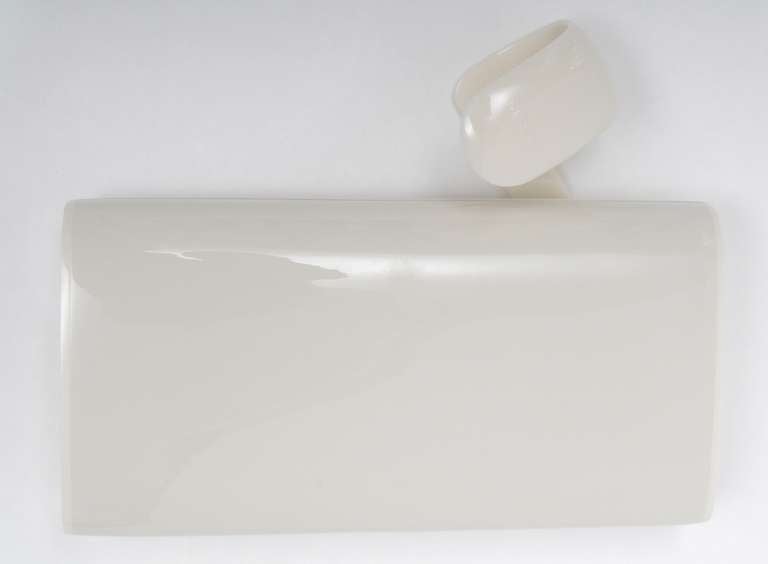 Sleek, modern lines, this ivory colored lucite clutch is a timeless staple. Levered closure. Brown satin lining. Roomy interior. 
Lucite has been kept in nearly perfect condition as no scratches can be noticed.