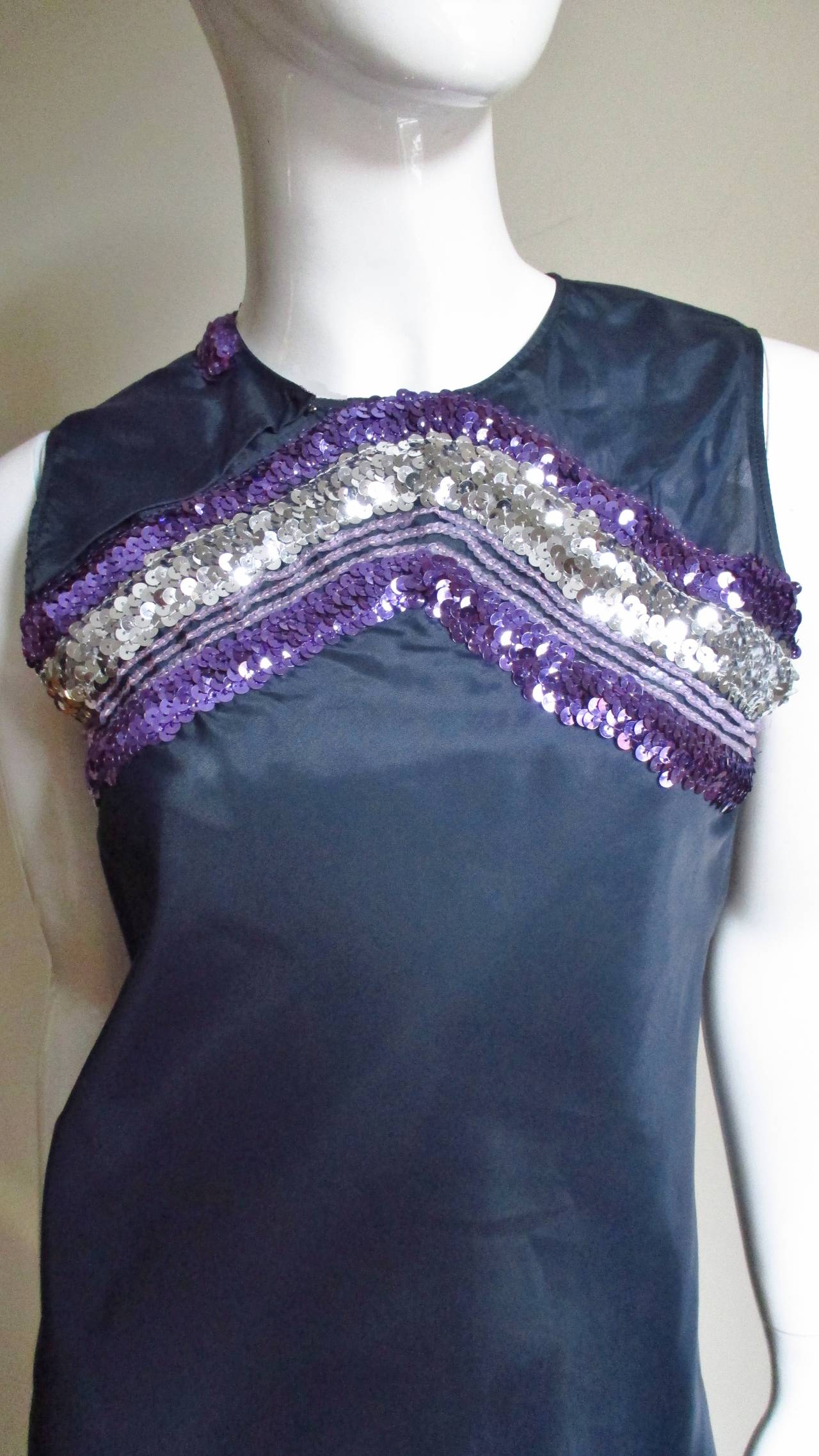 A great dress from Helmut Lang's early collections in dark blue taffeta with fabulous lavender and silver sequins forming an inverted V above the front bustline, the lavender sequins extending around the left armhole across to the neckline in the