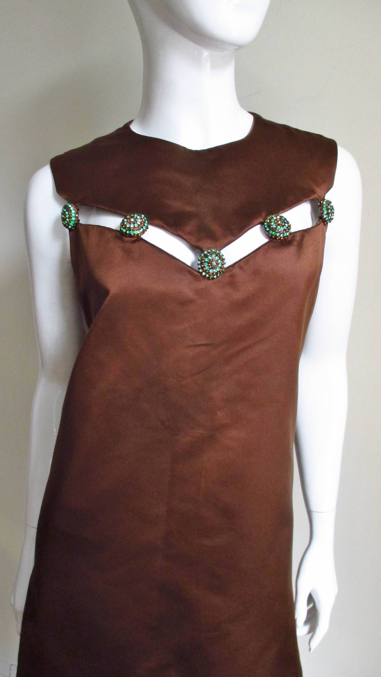 A fabulous silk dress in a rich chocolate brown from Christian Dior. It has a dramatic sweetheart shaped yoke attached to dress with 5 gorgeous green and brown rhinestone buttons which allow a 1