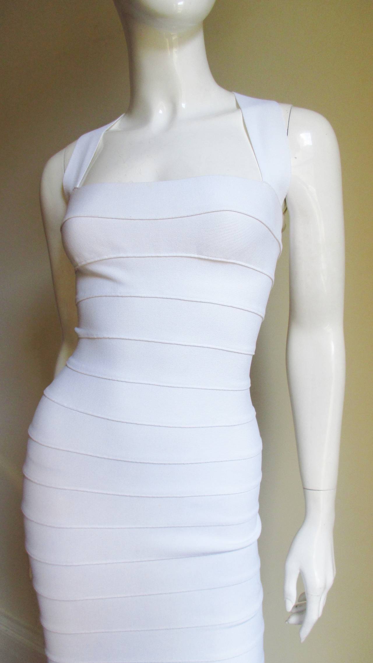 When he sold his company in the 1990s Herve Leger began designing as the label Herve Leroux. This dress is the same high quality substantial bandage fabrication and body conscious designs he is famous for.  It is the ultimate white wiggle dress-