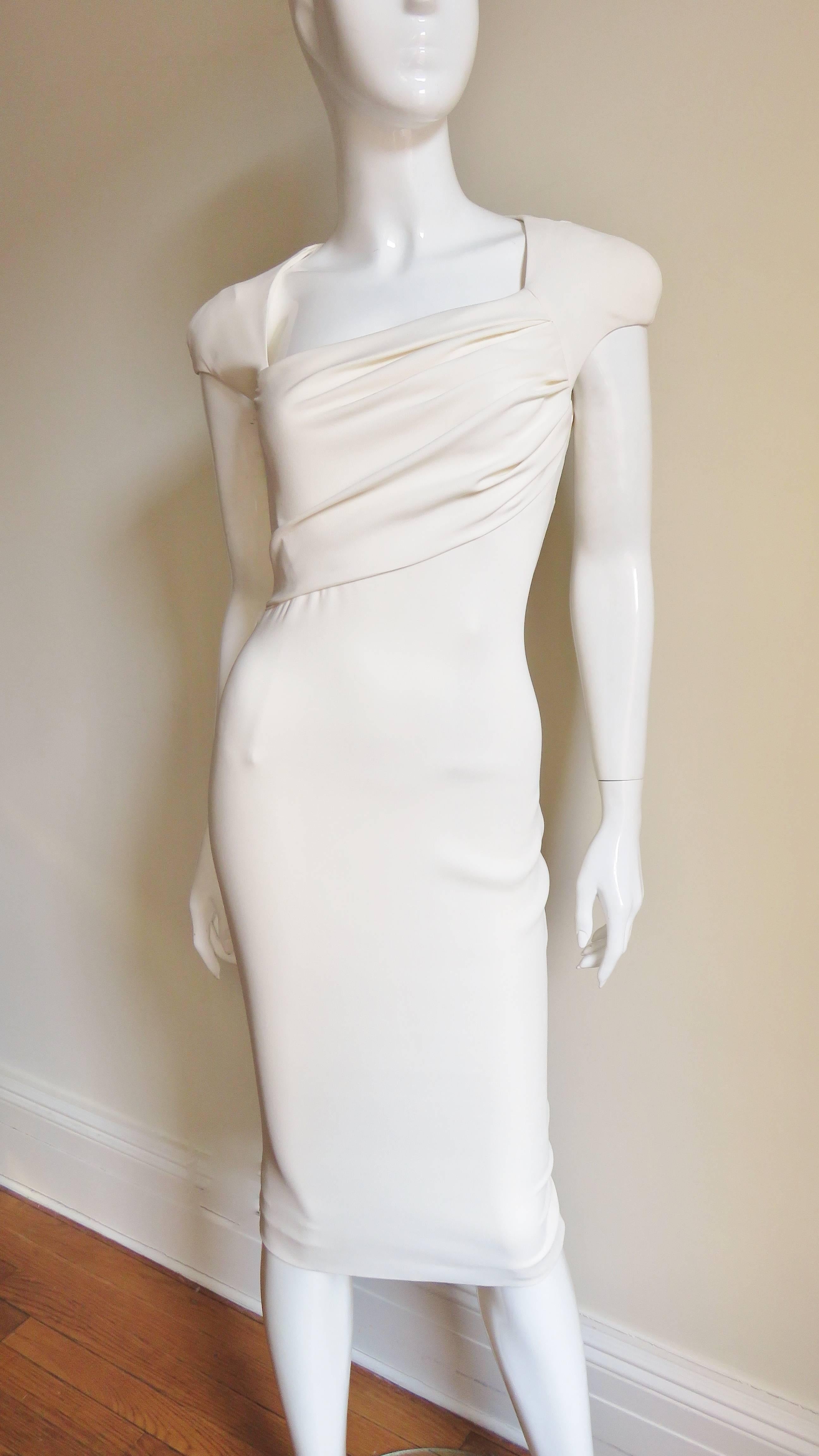 An incredible iconic set from Tom Ford 2012 collection in off white silk jersey, an identical but shorter and rarer version of what Gwyneth Paltrow to the Oscars that year.  It consists of a body conscious dress with an asymmetrical neckline and