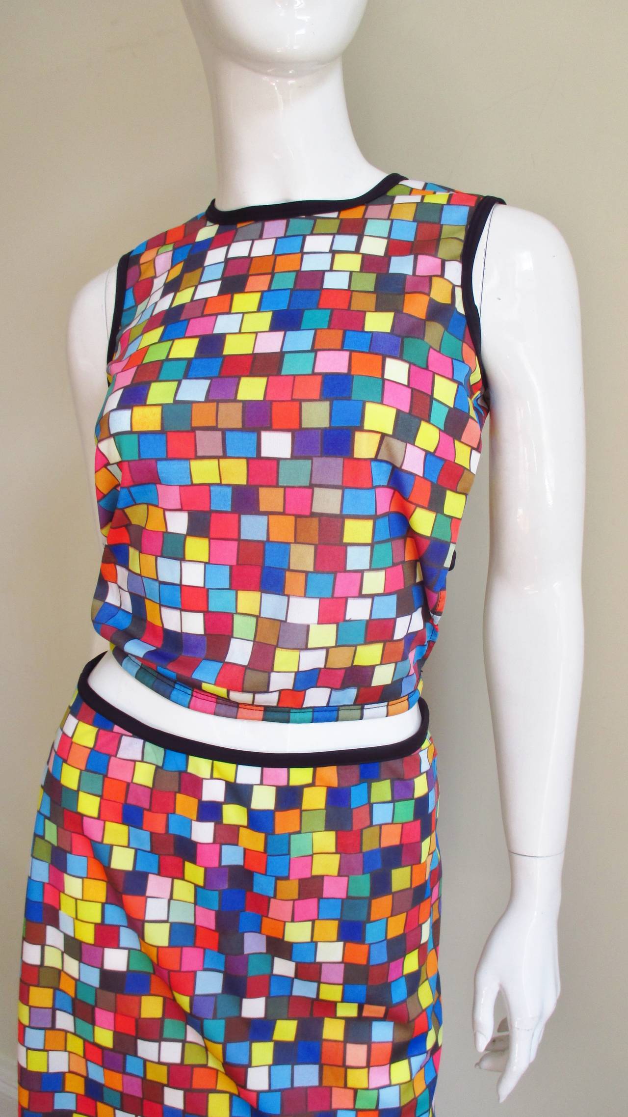 A fab 2 piece jersey set from designer Todd Oldham in a brightly colored check pattern.  It consists of a midriff top with a cutout tie back and a functional drawstring front hem and a mini A line skirt.  Both slip on and are unlined.  Neck,