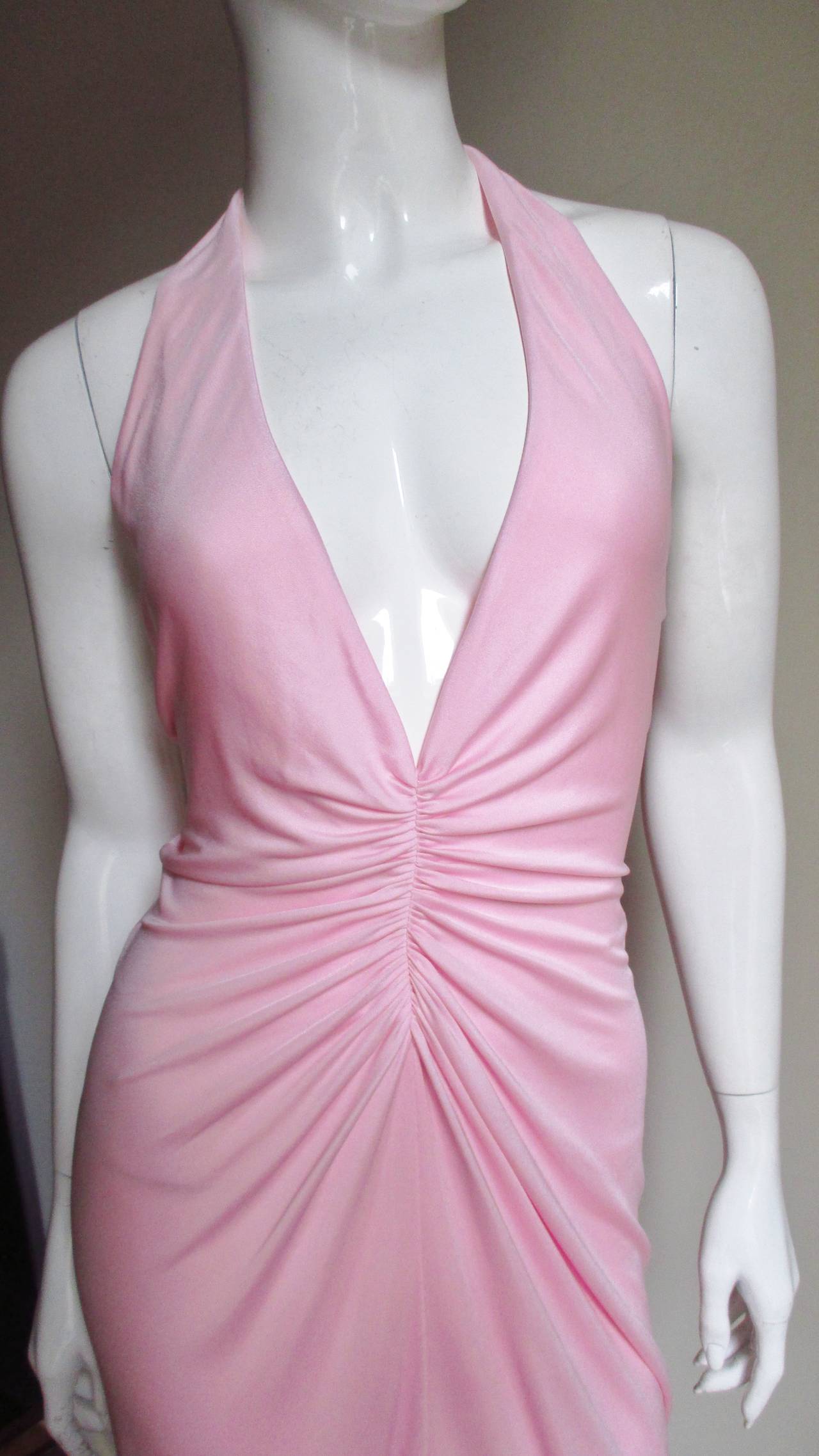 Another great plunge halter with impeccable fit in a soft pink silk jersey from Versace.  It has a flattering plunge V neckline with soft ruching along the center front and back through to the hips enhancing the fit and shape.  The skirt skims the