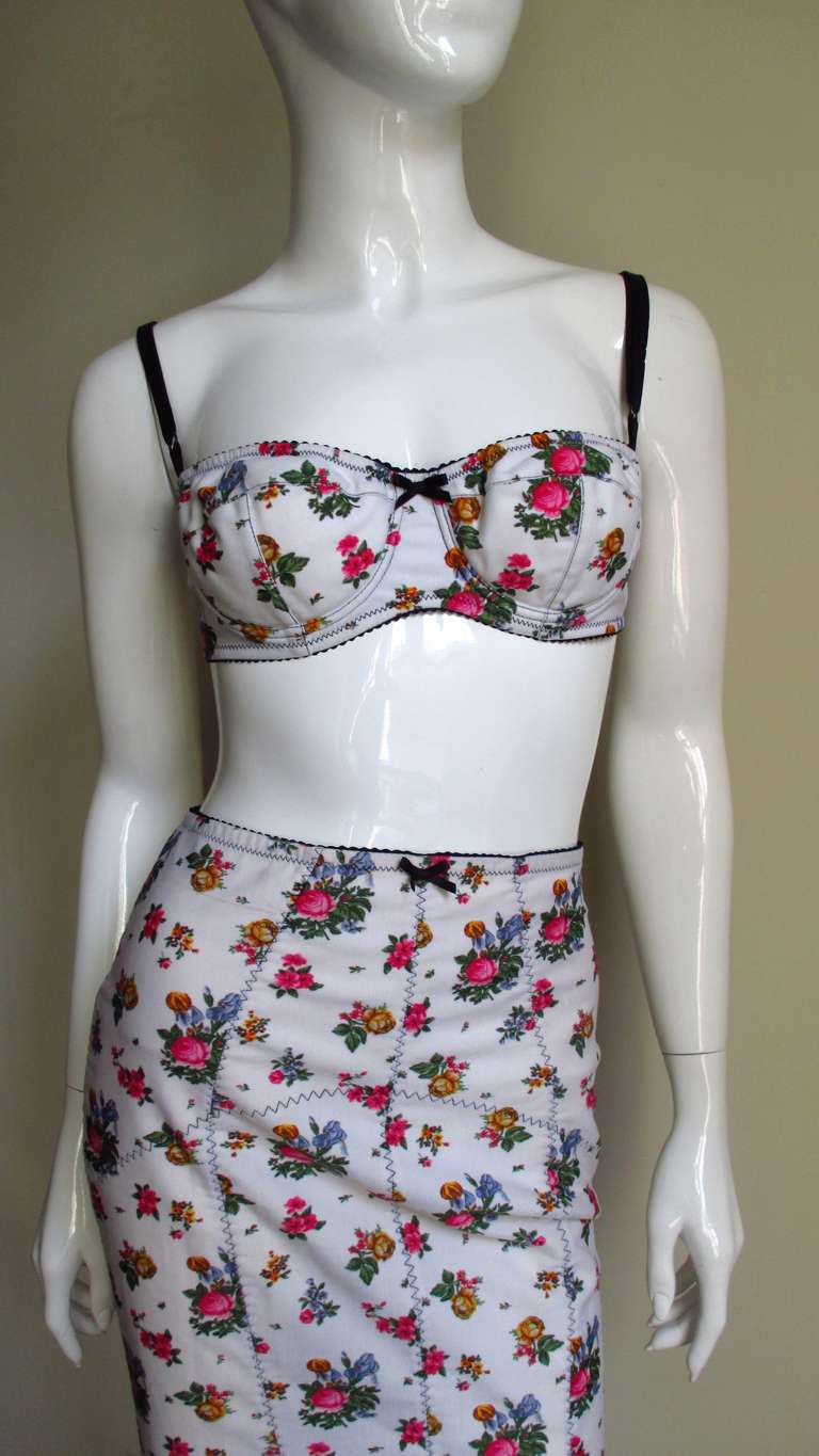 Hot hot hot...a 3 piece set from the masters of sexy- Dolce and Gabbana, consisting of a bra, silk shirt and corset style skirt all in a rose pattern on an off white background.  The underwire bra has adjustable black straps and closes in the back